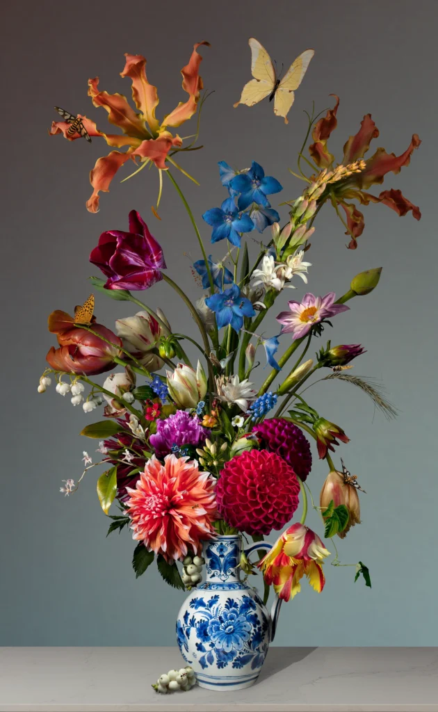 Dahlias, tulips, gloriosa and blue delphinium in a small Delft blue vase, with a butterfly hovering above.
