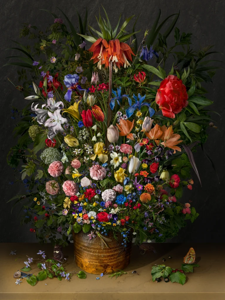 A tightly packed bouquet topped by a crown imperial, in an earthenware pot on a ledge with scattered petals and insects.