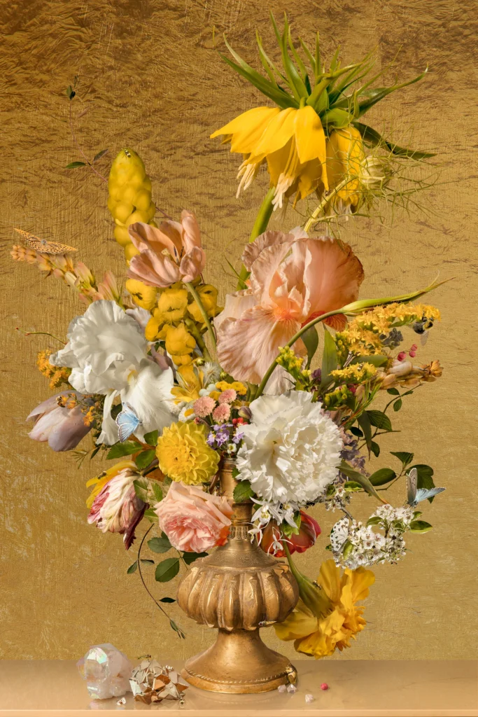An overflowing bouquet of iris, peony, tulips and yellow spikes in a gilded urn against a gold-leaf ground.