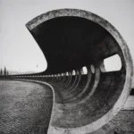 A sweeping concrete shell curving over a cobbled square, its hollow underside opening towards the viewer.